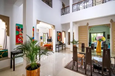 a living room with a dining table and chairs at Villa Lumina in Marrakech