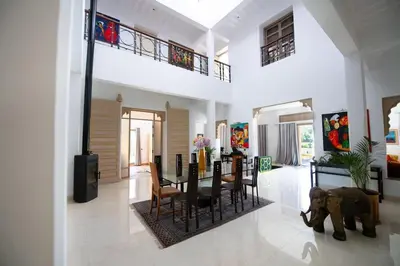 a dining room and living room with an elephant in a house at Villa Lumina in Marrakech