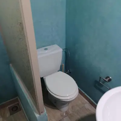 a bathroom with a white toilet and a sink at Maison d´hôtes Amazir in Ouzoud