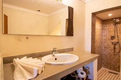 a bathroom with a sink and a shower at Villa avec piscine chauffée Eden Marrakchi in Marrakech