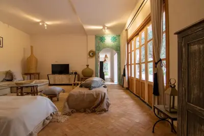 a bedroom with two beds and a living room at Villa avec piscine chauffée Eden Marrakchi in Marrakech