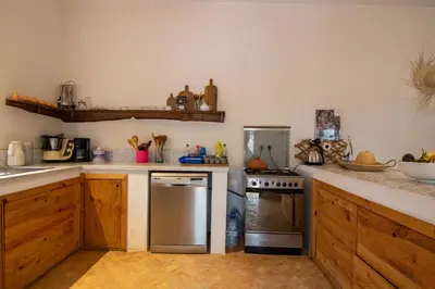 a kitchen with a stainless steel refrigerator and a stove at Villa avec piscine chauffée Eden Marrakchi in Marrakech