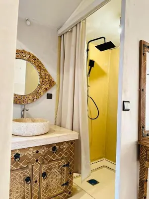 a bathroom with a sink and a mirror at Desert Night Luxury Camp in Merzouga