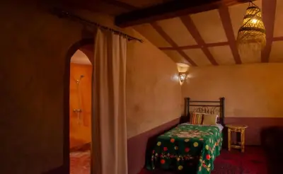 a bedroom with a bed in a room with a ceiling at Sahara Escape tours in Mhamid