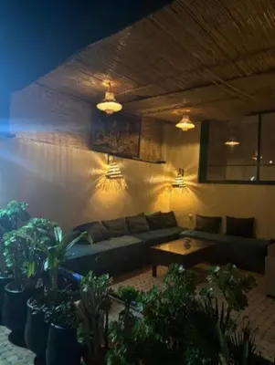 a living room with a couch and a table at Riad Tilal Fes & spa in Fès