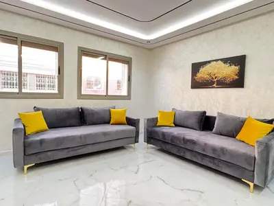 two couches in a living room with yellow pillows at Fes shore listings in Fès