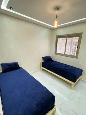 a bedroom with two beds and a window at Fes shore listings in Fès