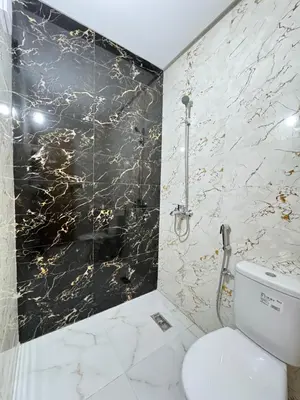 a bathroom with a black and gold marble wall at Fes shore listings in Fès