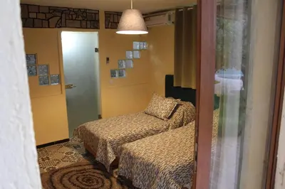 a bedroom with a bed and a door to a room at Gîte rural à Jnane Imass in Jnane Imes