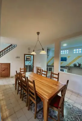 a dining room with a wooden table and chairs at Gîte rural à Jnane Imass in Jnane Imes