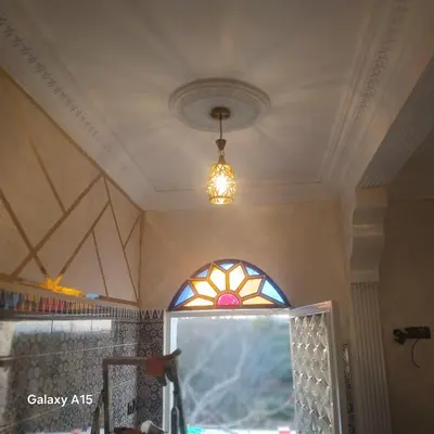 a room with a window and a pendant light at Maison d'Azur in Sidi Abdalwahad