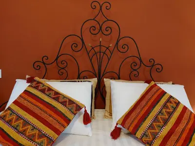 a bed with a black headboard and two pillows at Dar HISANE in Marrakech