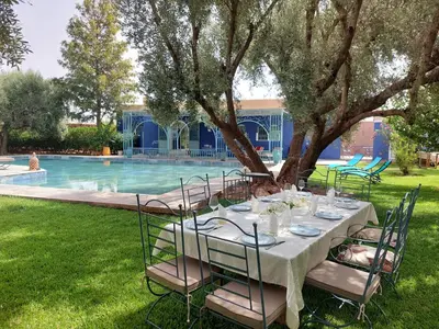 a table set up for a party in front of a pool at Dar HISANE in Marrakech