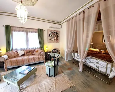 a living room with a couch and a bed at Dar HISANE in Marrakech