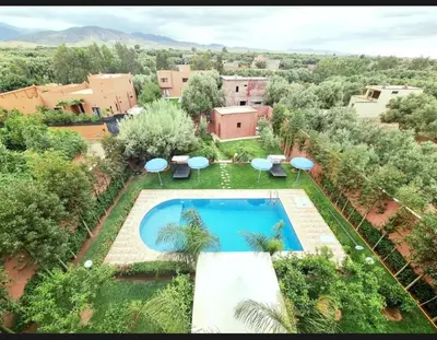 an overhead view of a swimming pool with umbrellas at Pool villa in Ourika in Ourika