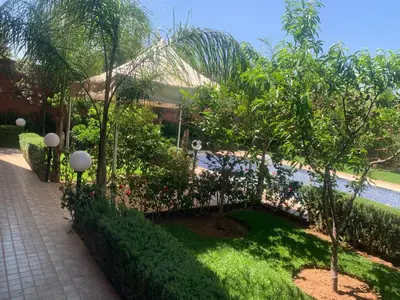 a garden with trees and a swimming pool at Pool villa in Ourika in Ourika