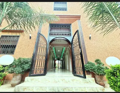 an entrance to a building with two iron gates at Pool villa in Ourika in Ourika