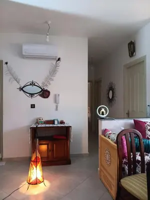 a living room with a couch and a fireplace at Appartement neuf équipé à Fez in Fès