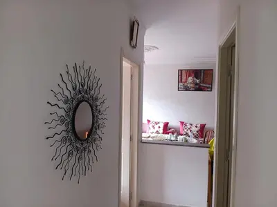 a mirror on the wall of a hallway at Appartement neuf équipé à Fez in Fès