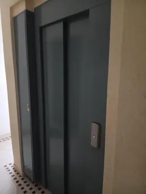 a glass door in a room with a wall at Appartement neuf équipé à Fez in Fès