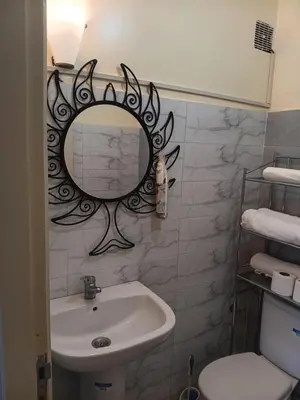 a bathroom with a sink and a mirror on the wall at Appartement neuf équipé à Fez in Fès