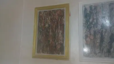 two paintings on a wall next to each other at Maison d'Azur in Sidi Abdalwahad