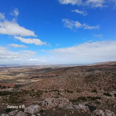 a view of a desert with rocks and a blue sky at Maison d'Azur in Sidi Abdalwahad