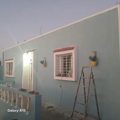 a room with a ladder and a white wall at Maison d'Azur in Sidi Abdalwahad
