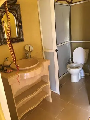 a bathroom with a sink and a toilet at Merzouga campsite in Merzouga