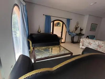 a living room with a couch and a window at Villa Michel Lucas in Marrakech