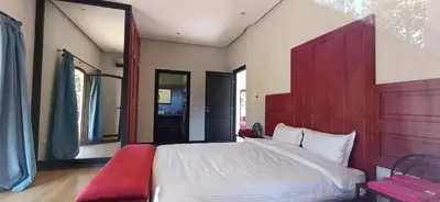 a bedroom with a large bed and a red headboard at Villa Michel Lucas in Marrakech