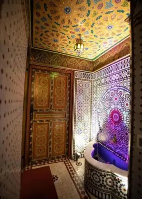 a bathroom with a tub with a painted ceiling at Dar Fez Mayssae in Fès