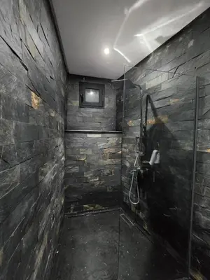 a bathroom with a shower with a glass door at Riad Sidi in Fès