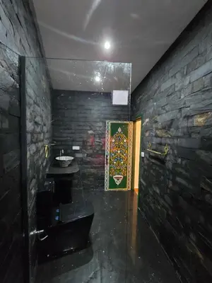 a bathroom with a sink and a stone wall at Riad Sidi in Fès