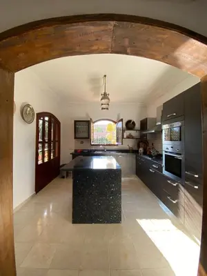 a kitchen with a black counter top in a room at Dar Mazaheer in Ouanina