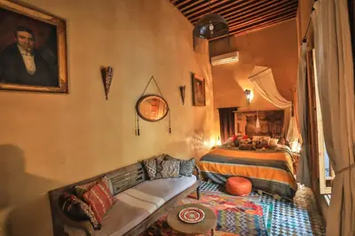 a bedroom with a bed and a couch in it at Fez Valley Luxury Camp in Fès