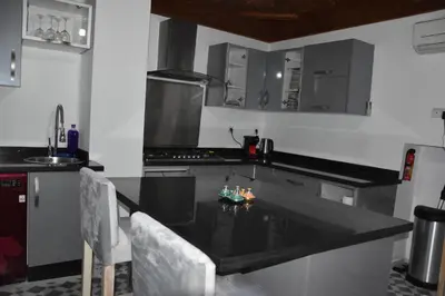 a kitchen with a black counter top in a room at Chambres Émeraude et Rubis - Riad Lotus Bleu in Fès