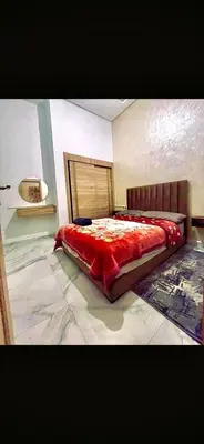 a bedroom with a large red bed in a room at Alia in Fès