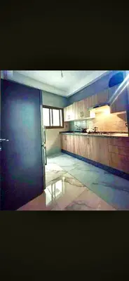 an empty room with a kitchen and a counter at Alia in Fès