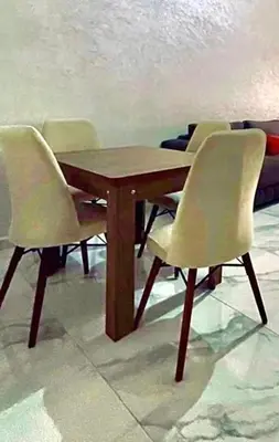 a wooden table with four chairs around it at Alia in Fès