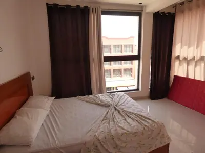 a bedroom with a bed and a large window at Diyafat Ghandi in Khenifra