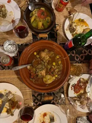 a table with a bowl of food and plates of food at discover luxury camp in Merzouga