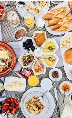 a table with many plates of food on it at discover luxury camp in Merzouga