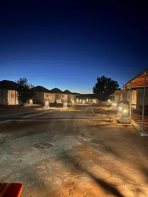 an empty parking lot next to a building at night at discover luxury camp in Merzouga