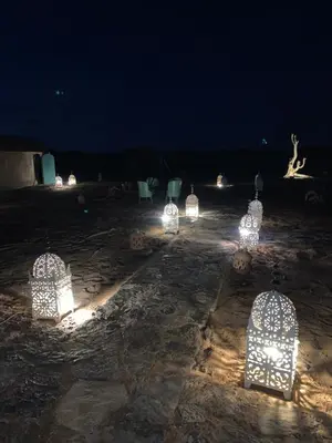 a group of cages with lights in the dark at Lunaluxurycamp in Merzouga