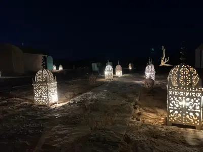 a group of lights in a yard at night at Lunaluxurycamp in Merzouga