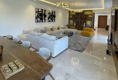 a living room with a couch and a table at Villa youssef in Oulad Tayeb