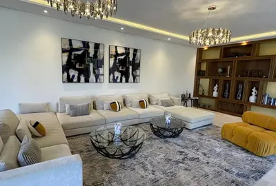 a living room with two couches and two tables at Villa youssef in Oulad Tayeb