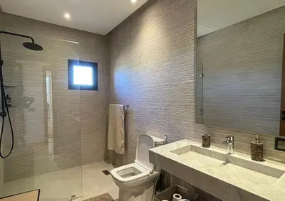 a bathroom with a toilet and a sink and a mirror at Villa youssef in Oulad Tayeb