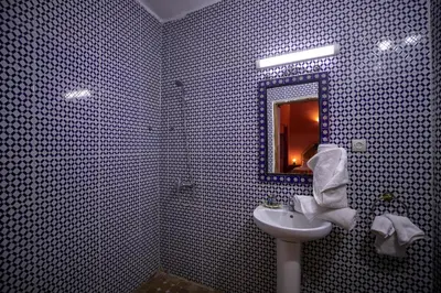 a bathroom with a sink and a mirror at Dar Nana fes in Fès